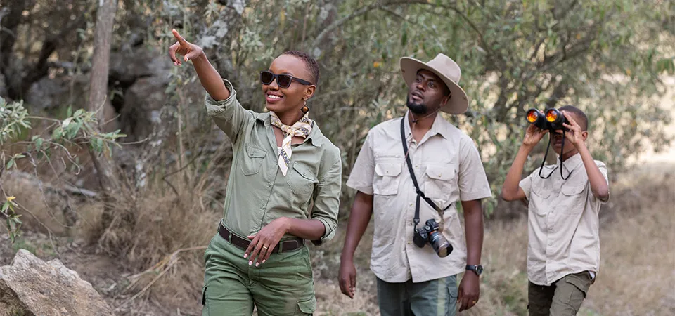 Tourists on a guided safari walk in Zimbabwe with a verified local guide.