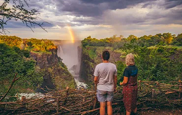 Tourists enjoying a safe view of Victoria Falls in Zimbabwe.
